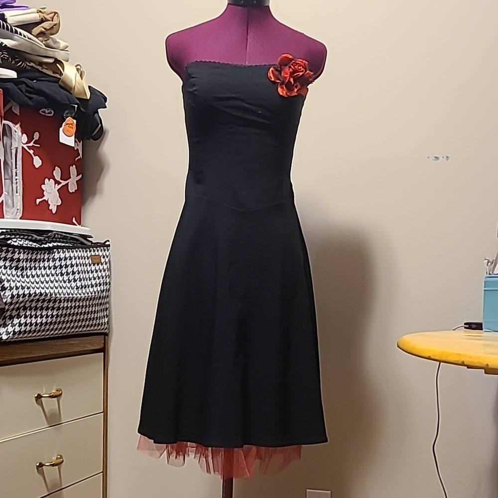Elegant Black Strapless Dress with Red Flower Accent